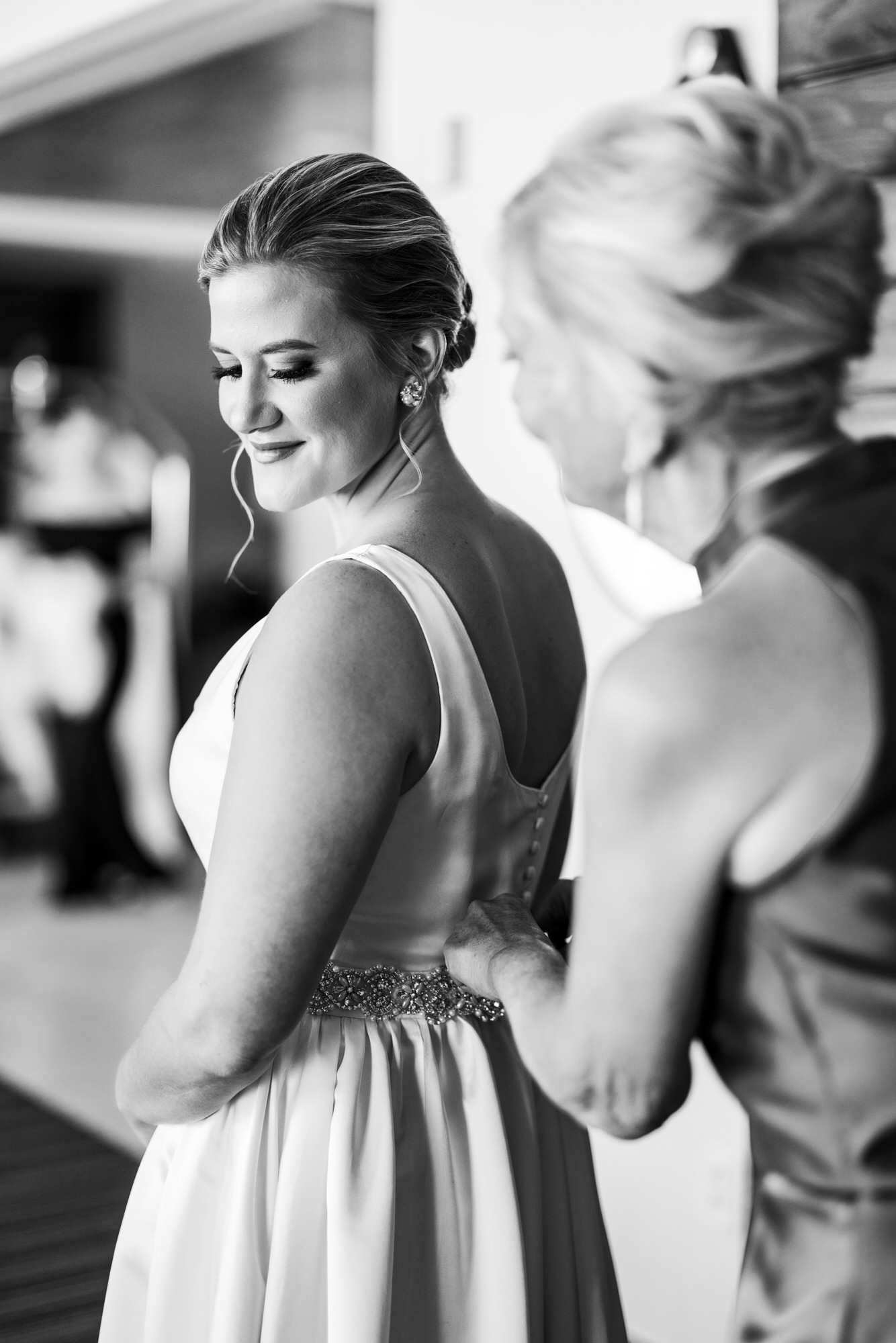 bride getting dressed with mother's help on black tie eastern shore wedding