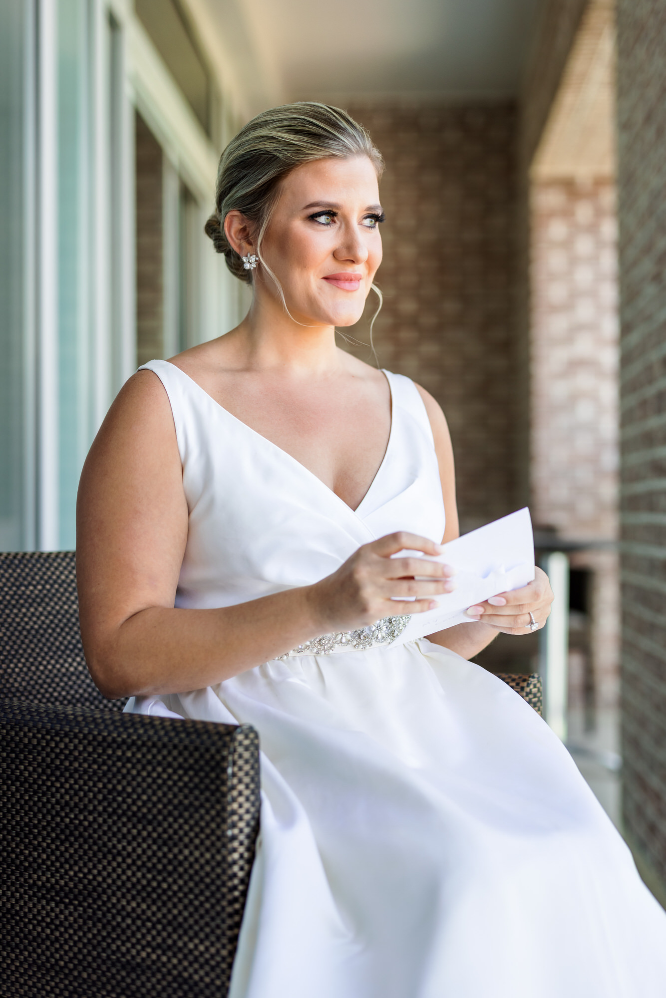 bride reading letter from groom on wedding day