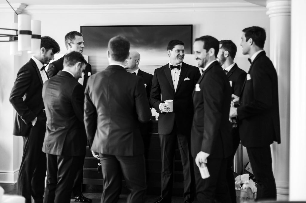 black and white groomsmen celebrating with groom