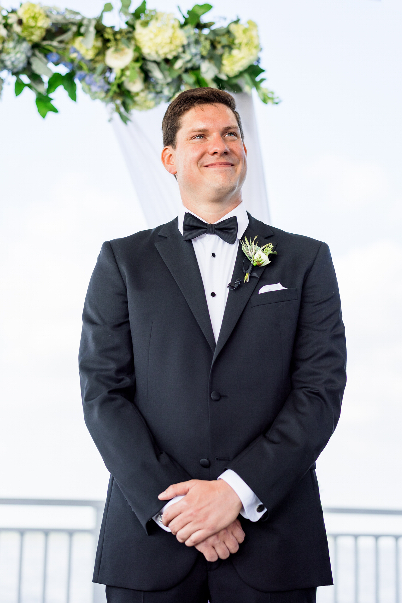 groom standing at alter waiting for bride at wedding ceremony