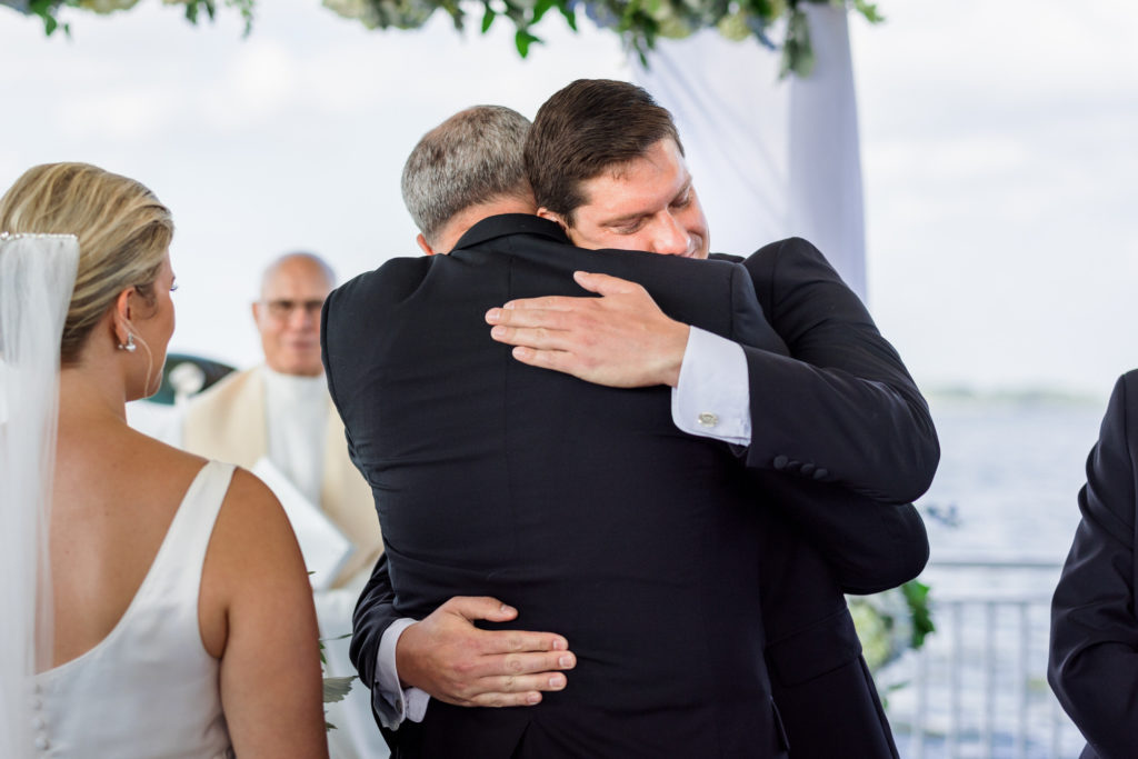 bride's father hugging groom