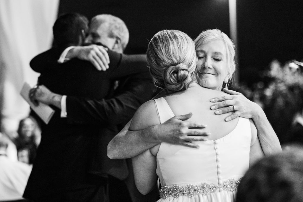 wedding couple hugging guests after speeches at black tie eastern shore wedding