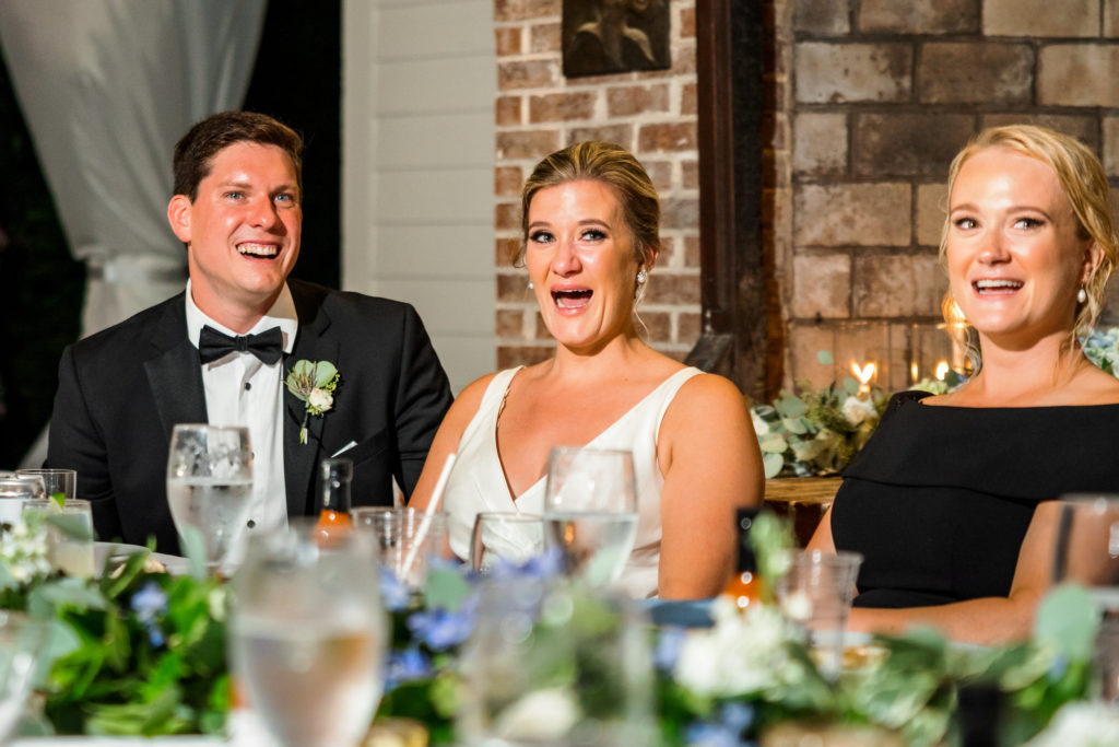 wedding couple laughing and smiling during speeches and toasts