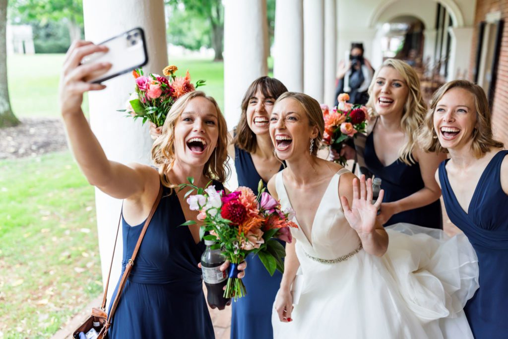 bridal party taking selfie before first look with groom