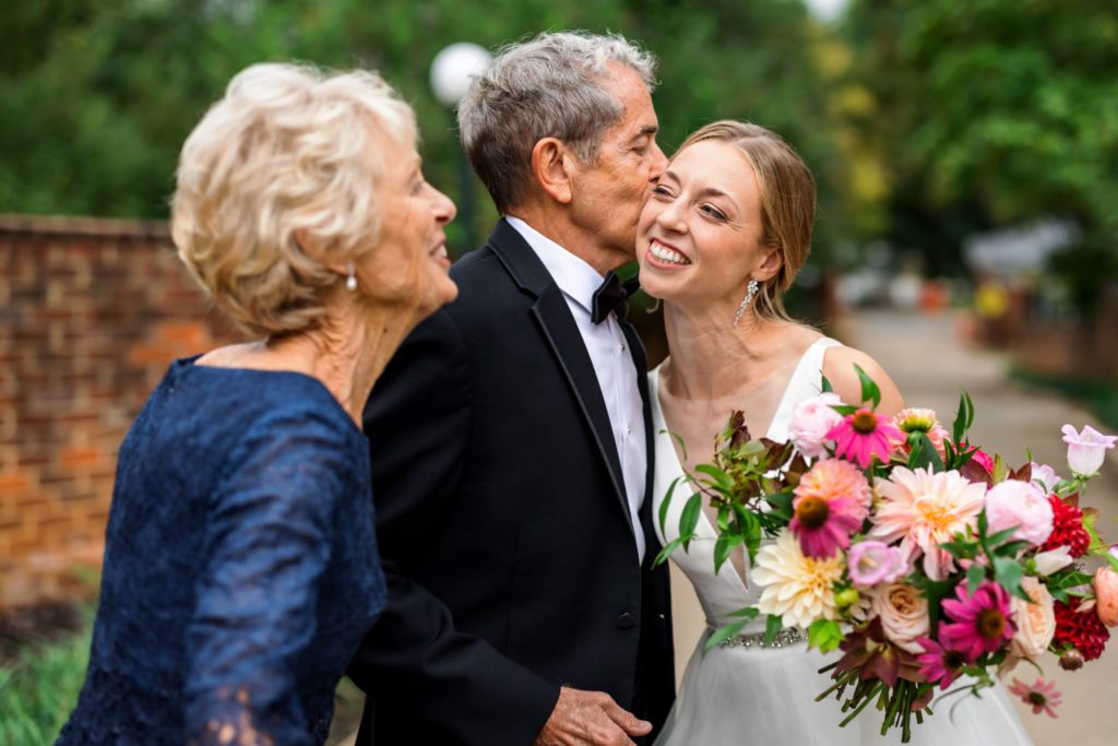 bride hugging family during portraits
