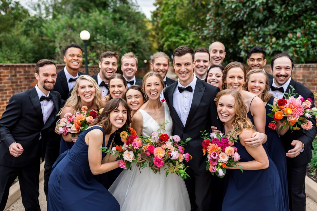 bridal party squeezing together during wool factory wedding portraits