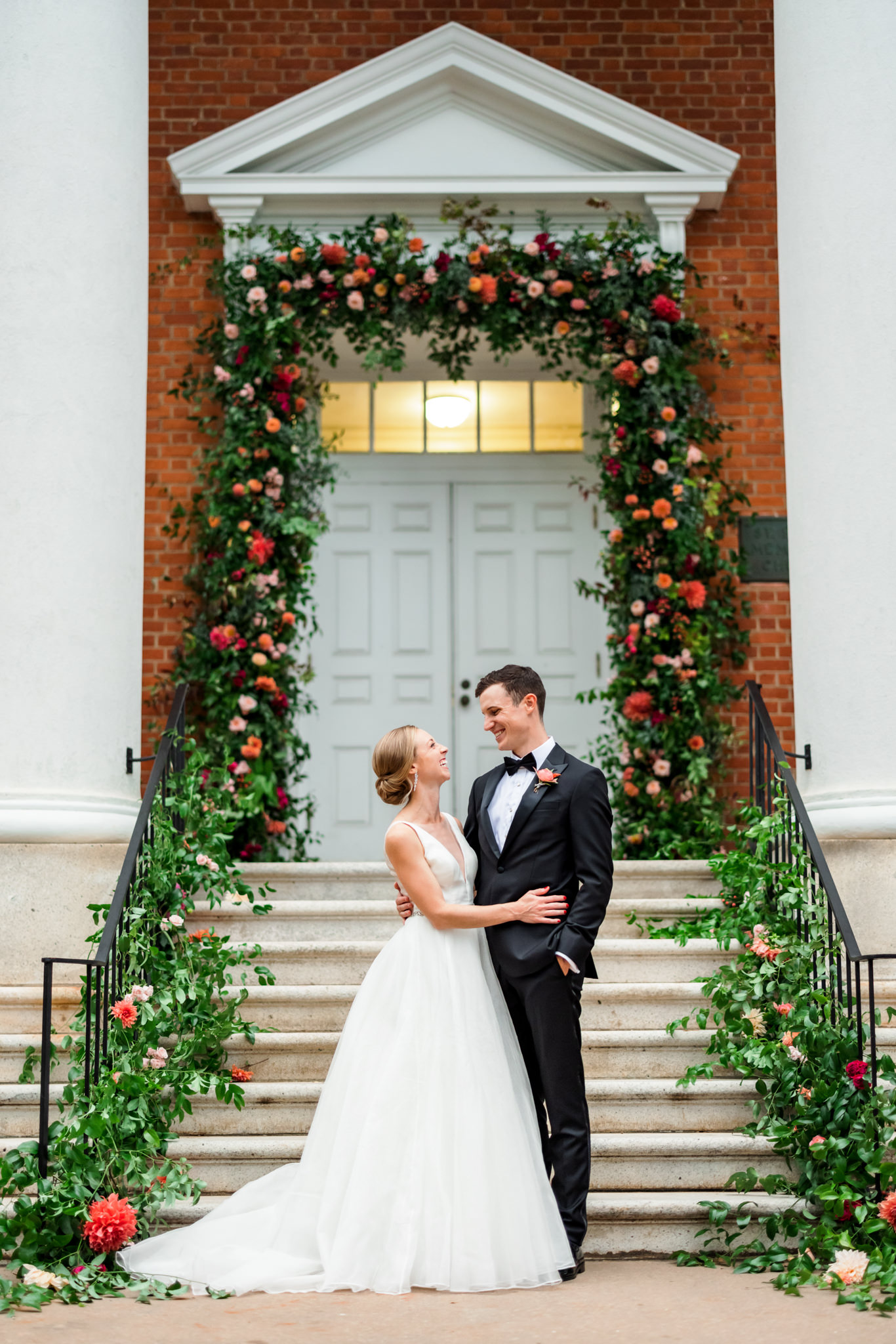 wedding couple embracing in front of stairs