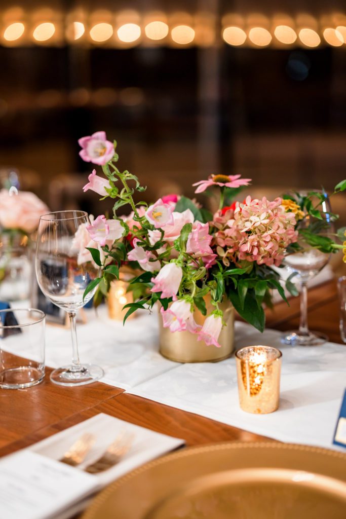 gold wedding table centerpieces with pink and red florals
