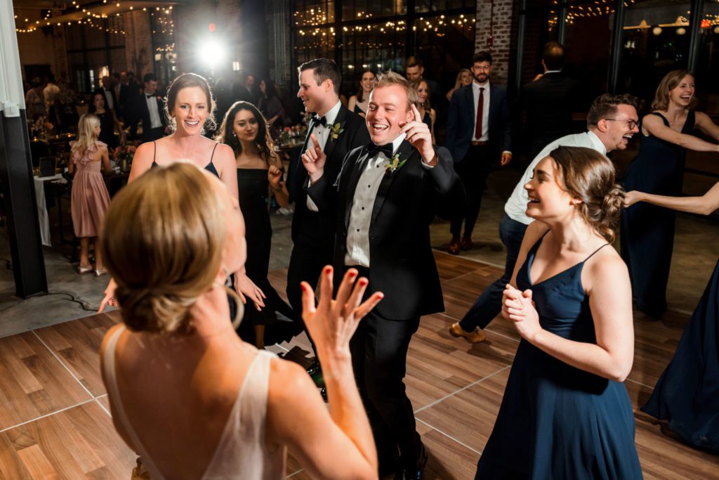 bride dancing with groom and wedding guests