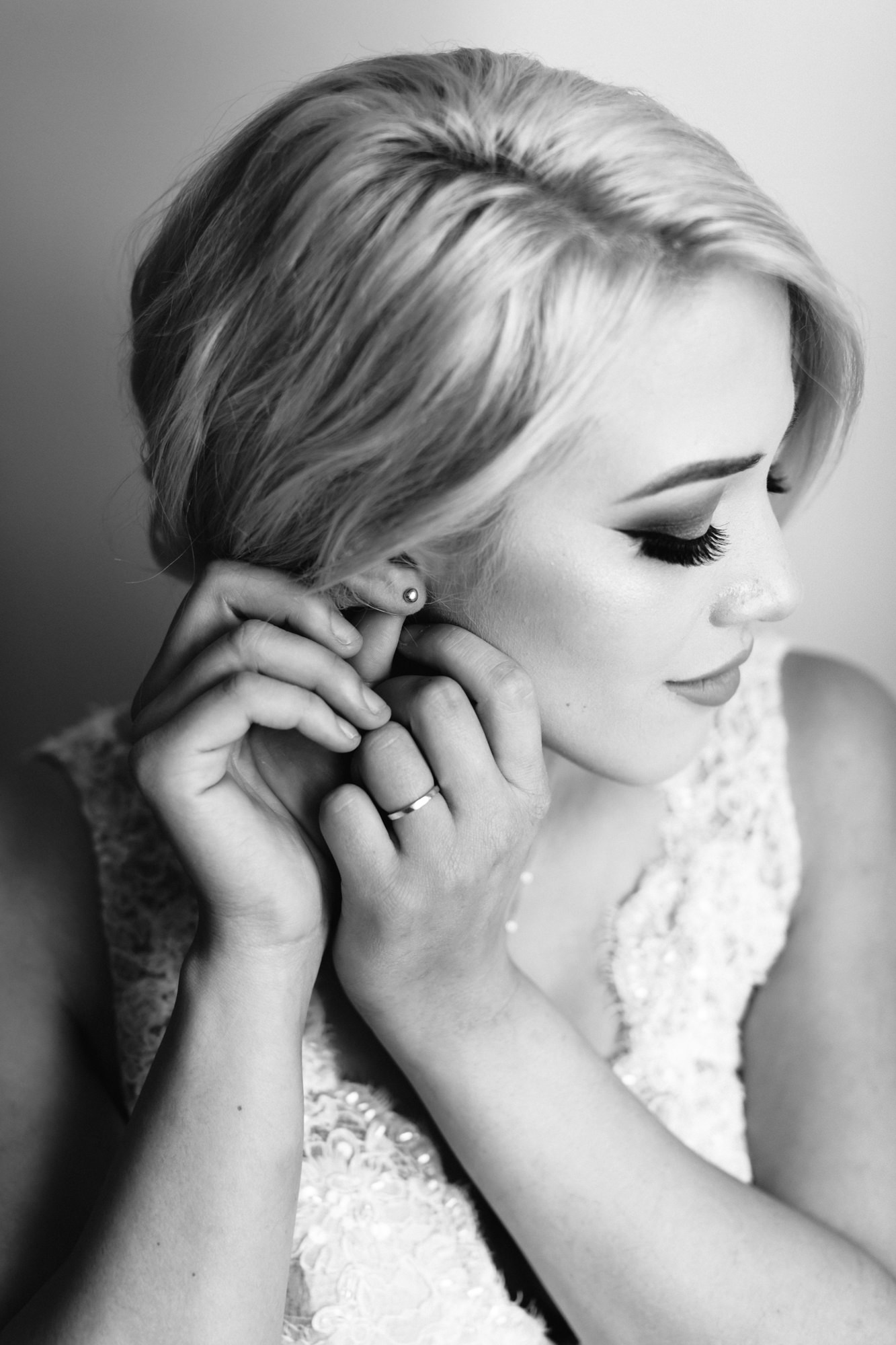 bride putting earrings on at spanish inspired styled wedding