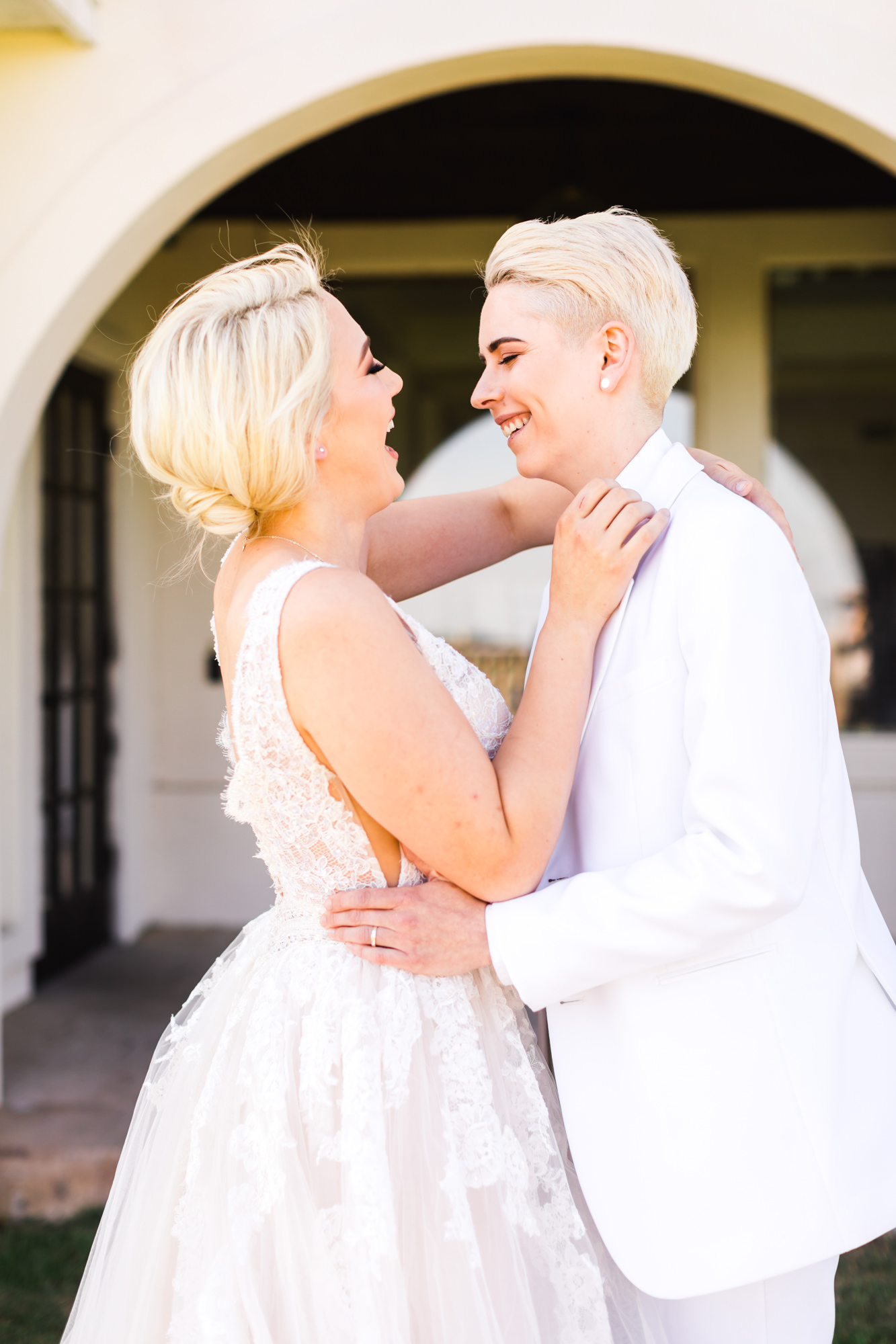 bridal couple embracing and laughing together