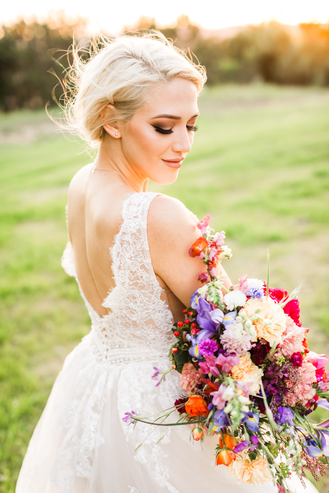 bridal portraits with bride wearing lace gown holding colorful bridal bouquet