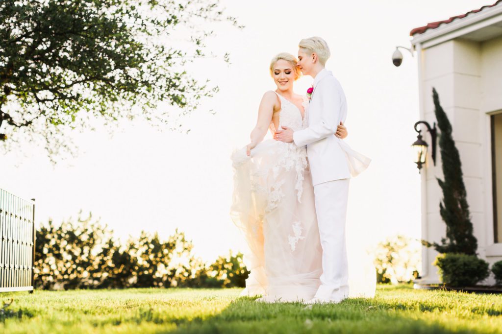 couple embracing and kissing during golden hour