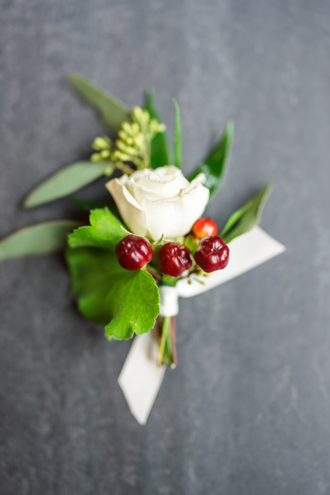 white rose boutonniere at intimate fall wool factory wedding 