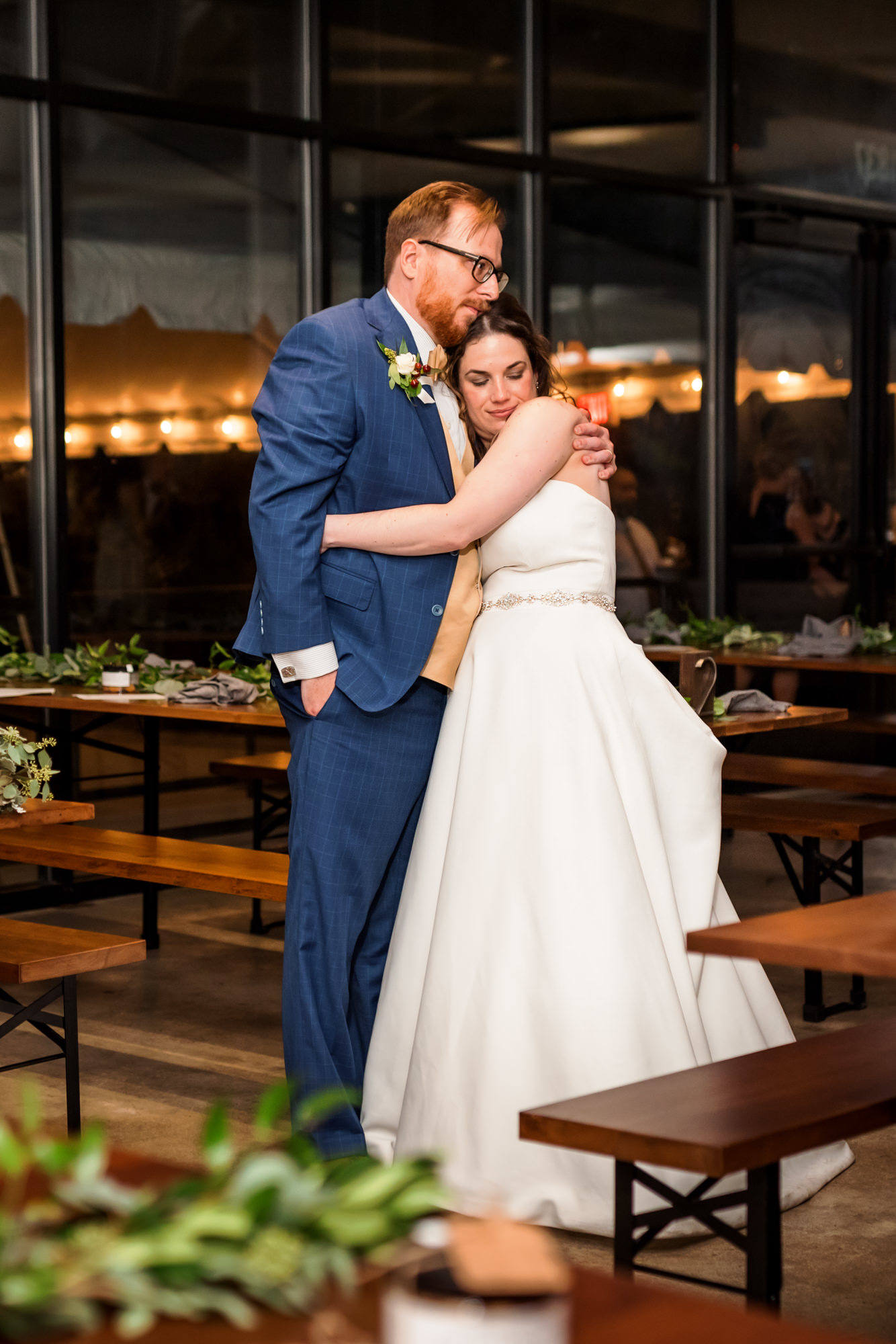 bride and groom hugging at intimate fall wool factory reception