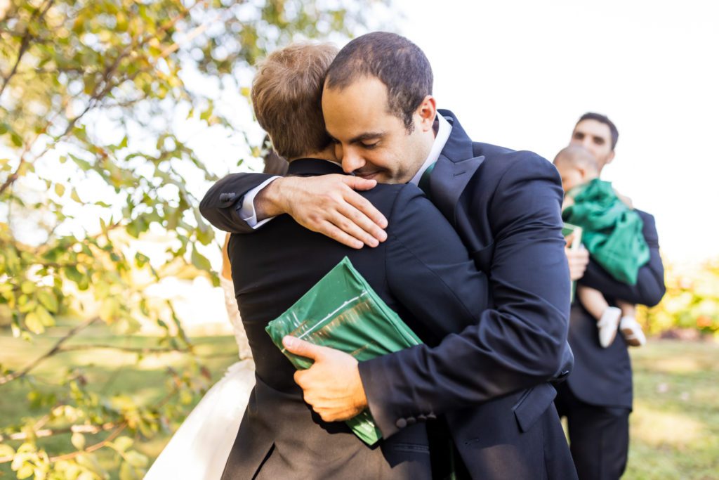 groom being hugged by groomsmen on wedding day