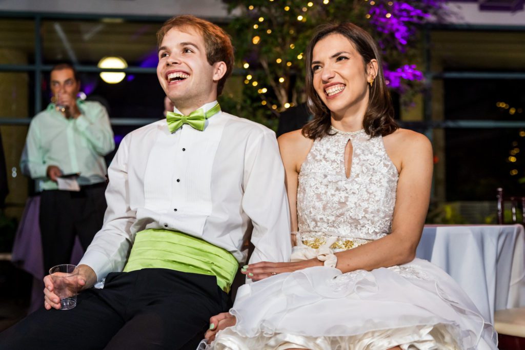 wedding couple smiling and laughing during speeches