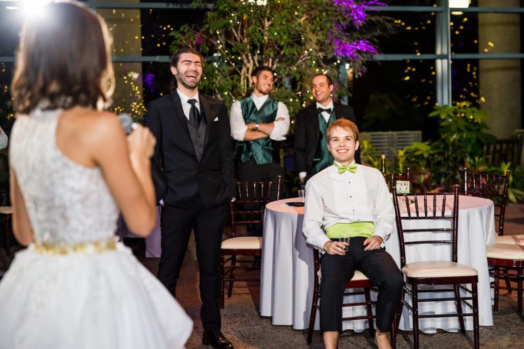 bride getting up to speak to guests and groom at Lebanese-American wedding reception