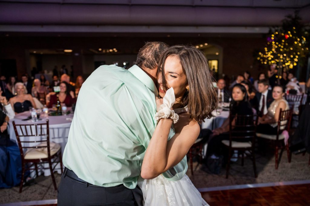 bride hugging father during father daughter dance