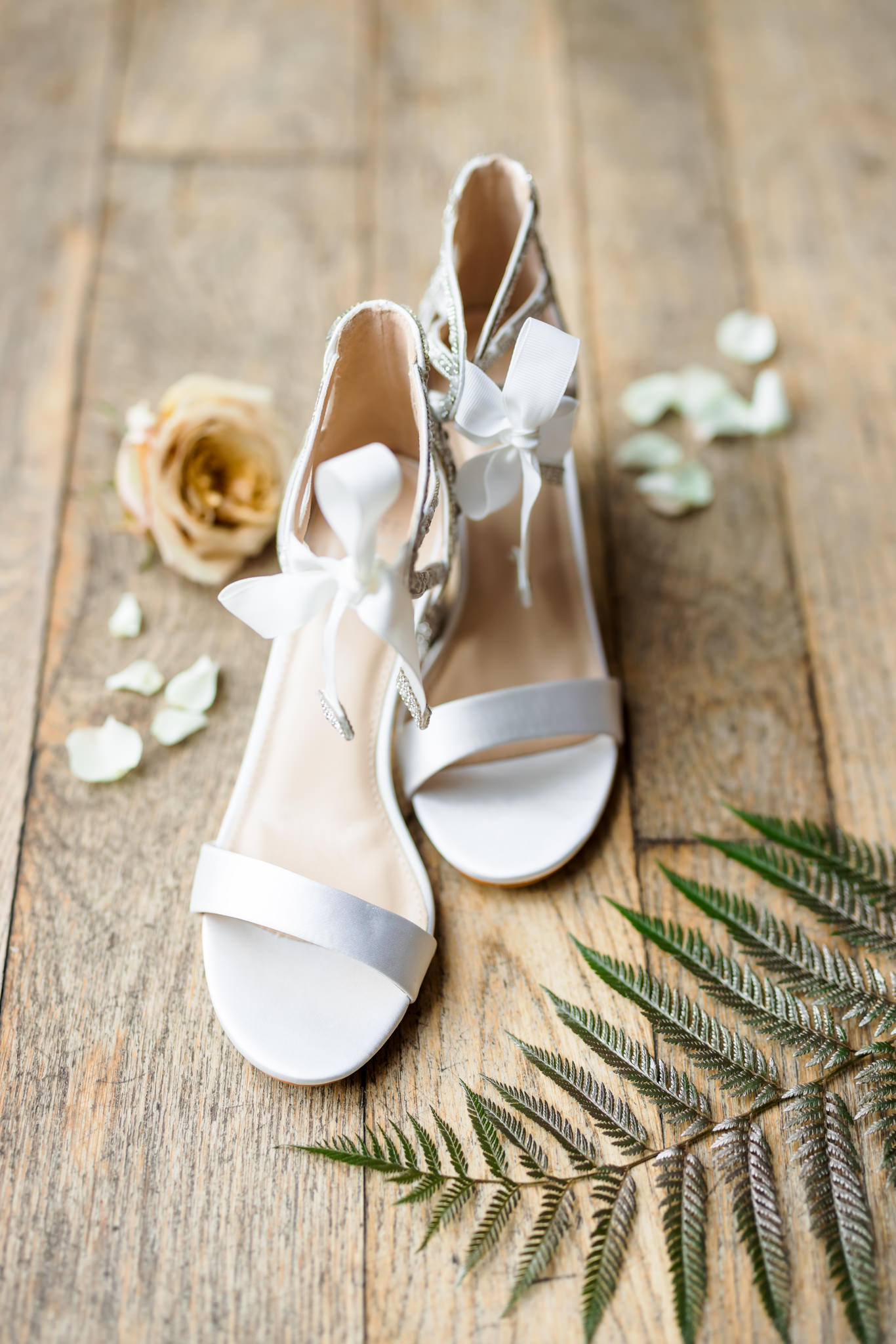 white bridal shoes with cream florals and greenery for bridal details