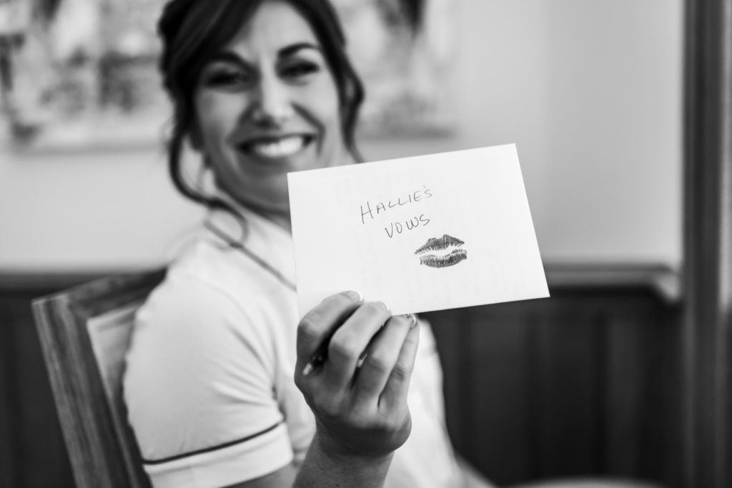 bride holding letter with lipstick kiss mark smiling