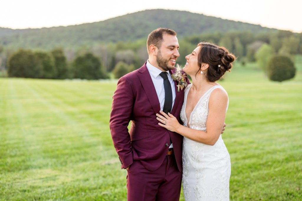 newly married couple looking at one another during outdoor bridal portraits