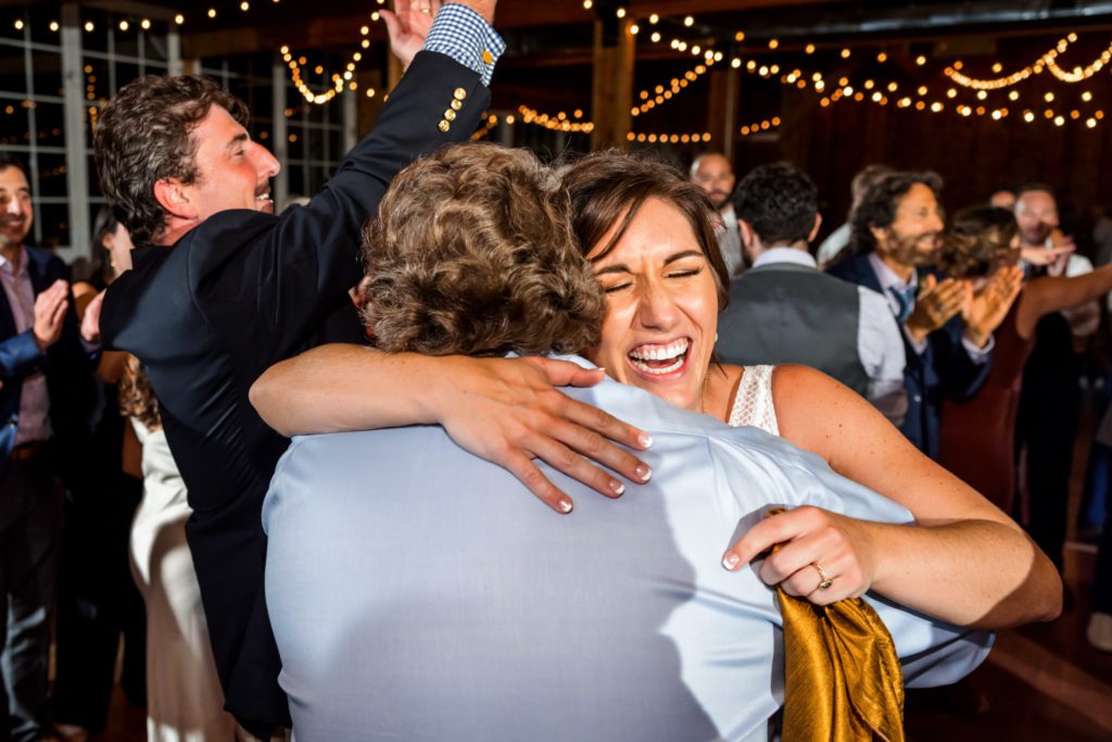 bride hugging family and guests during fall castle hill cider wedding reception