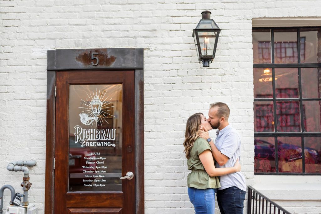 couple kissing outside of brewery