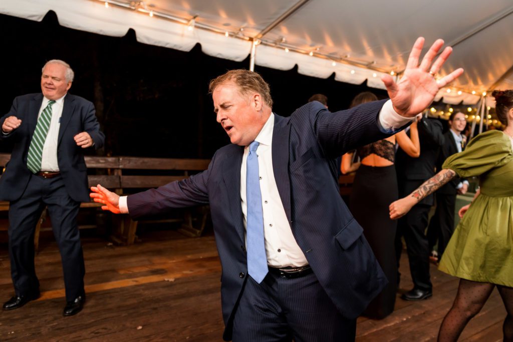 wedding guest dancing with arms out 