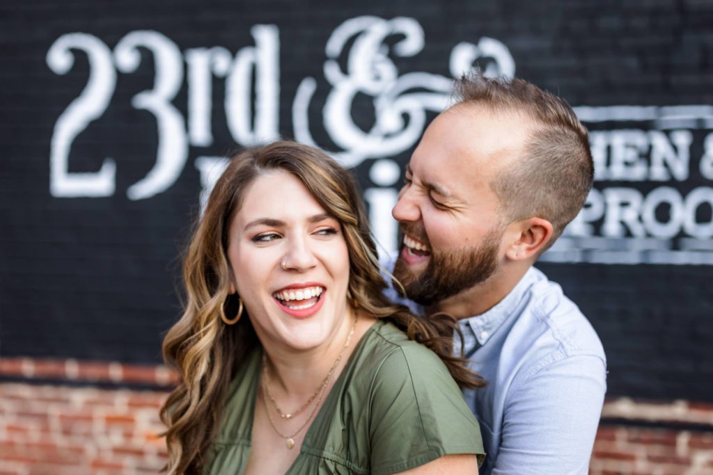 man and woman laughing during outdoor engagement session