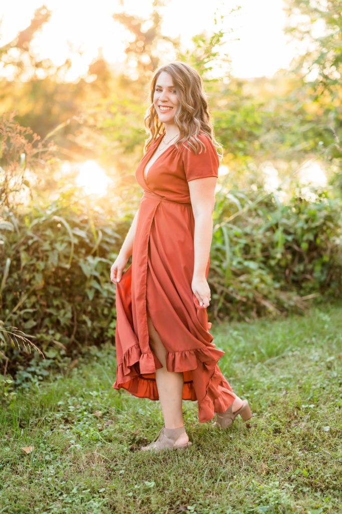 woman wearing dress spinning during outdoor engagement session