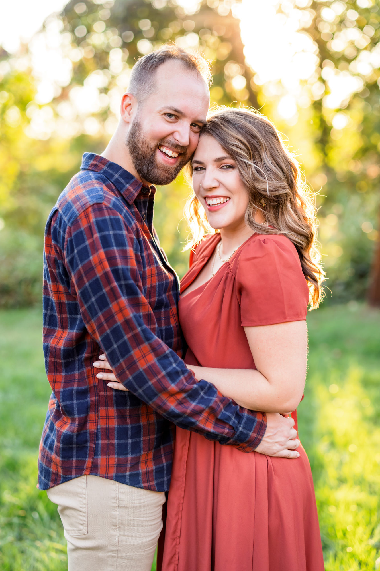 newly engaged couple wearing rust colored clothing during fall engagements