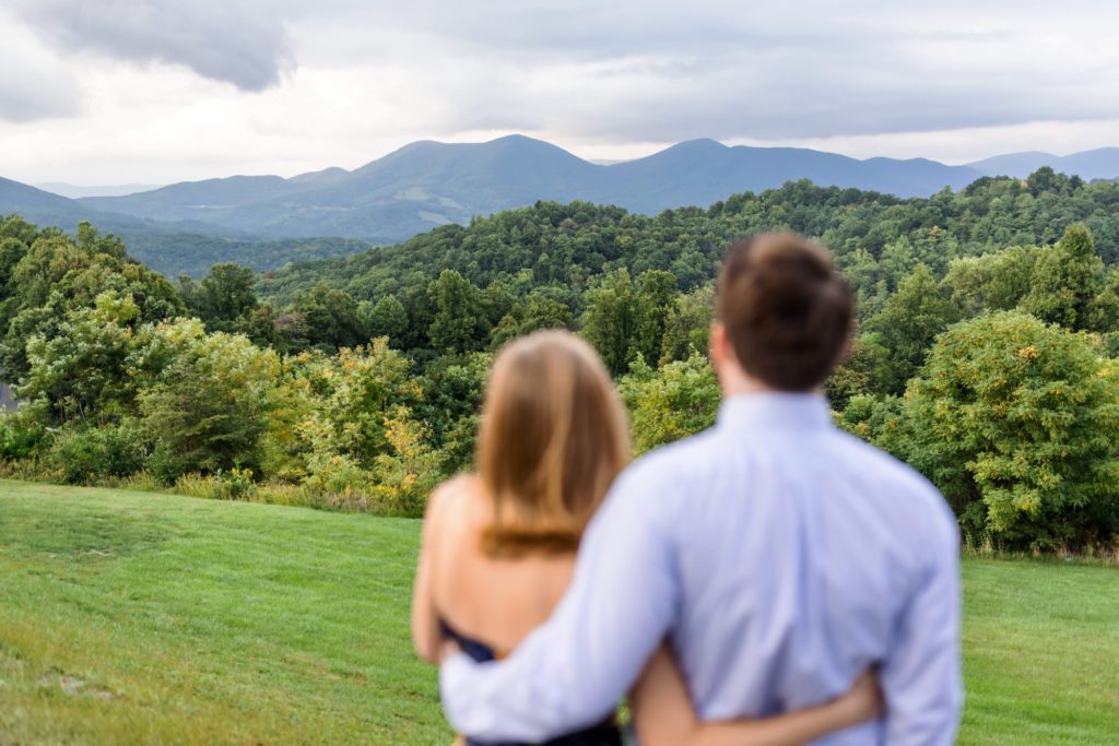 couple looking at blue ridge mountainscape during outdoor session