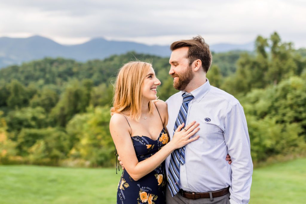 newly engaged couple looking at one another at House Mountain Inn