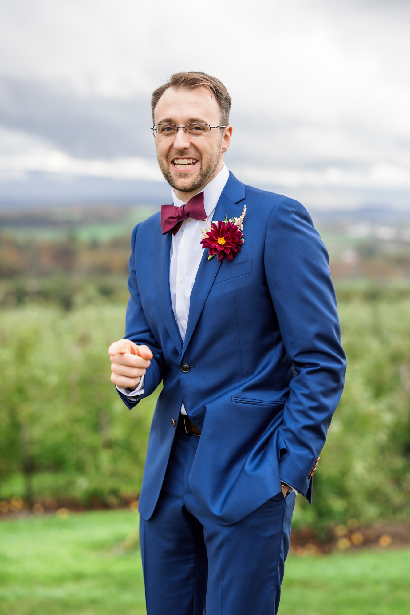 groom laughing and smiling during portraits