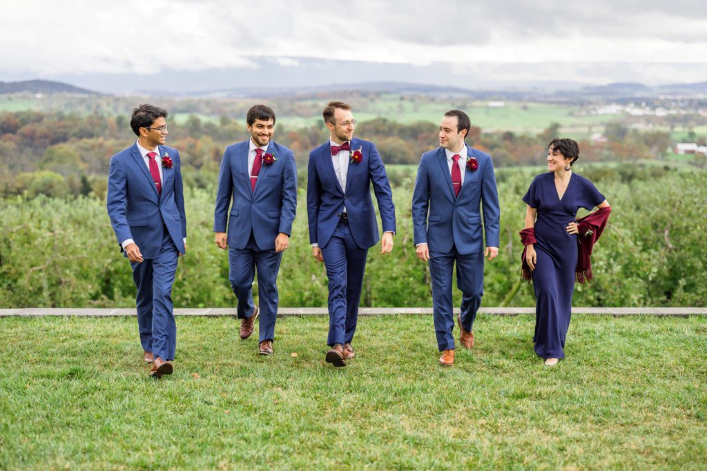 groom walking with bridal party on showalters greenhouse wedding day