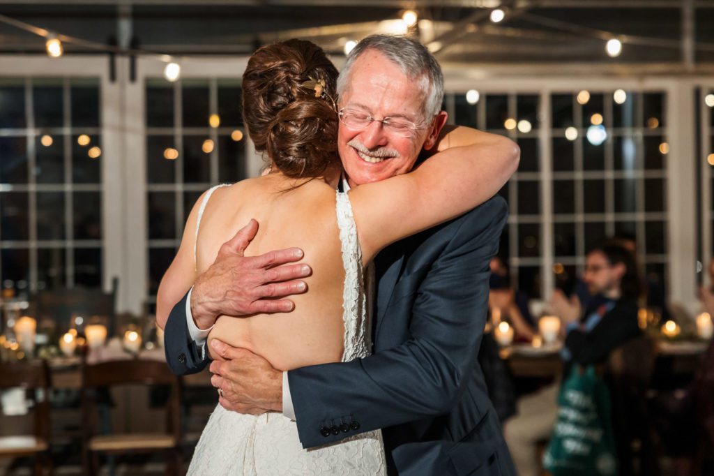 bride hugging father after father daughter dance