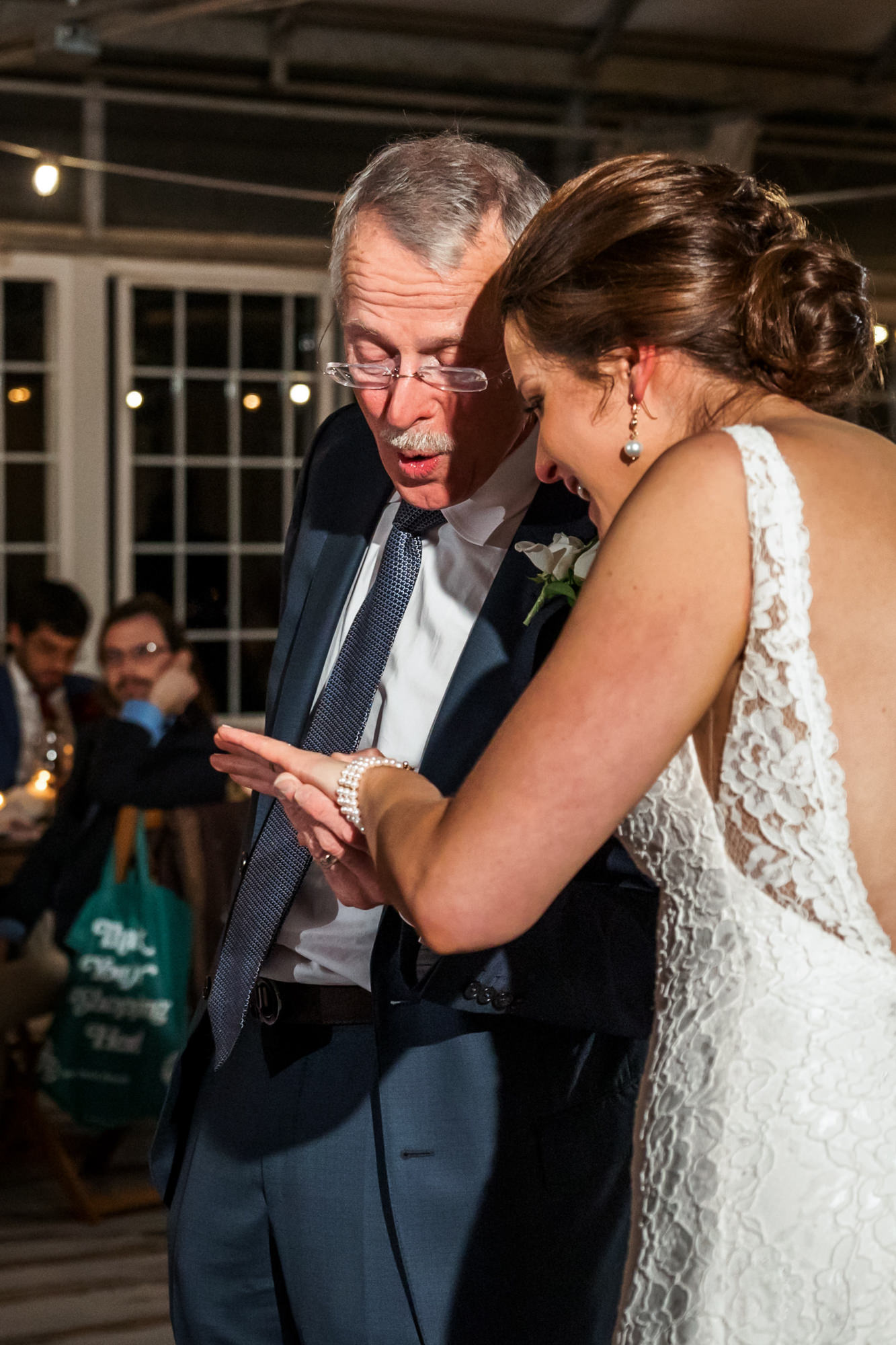 bride and father looking at ring