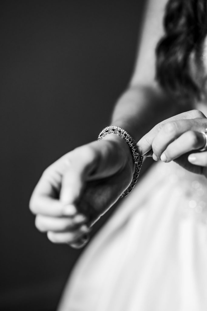 bride adjusting bracelet during bridal portraits