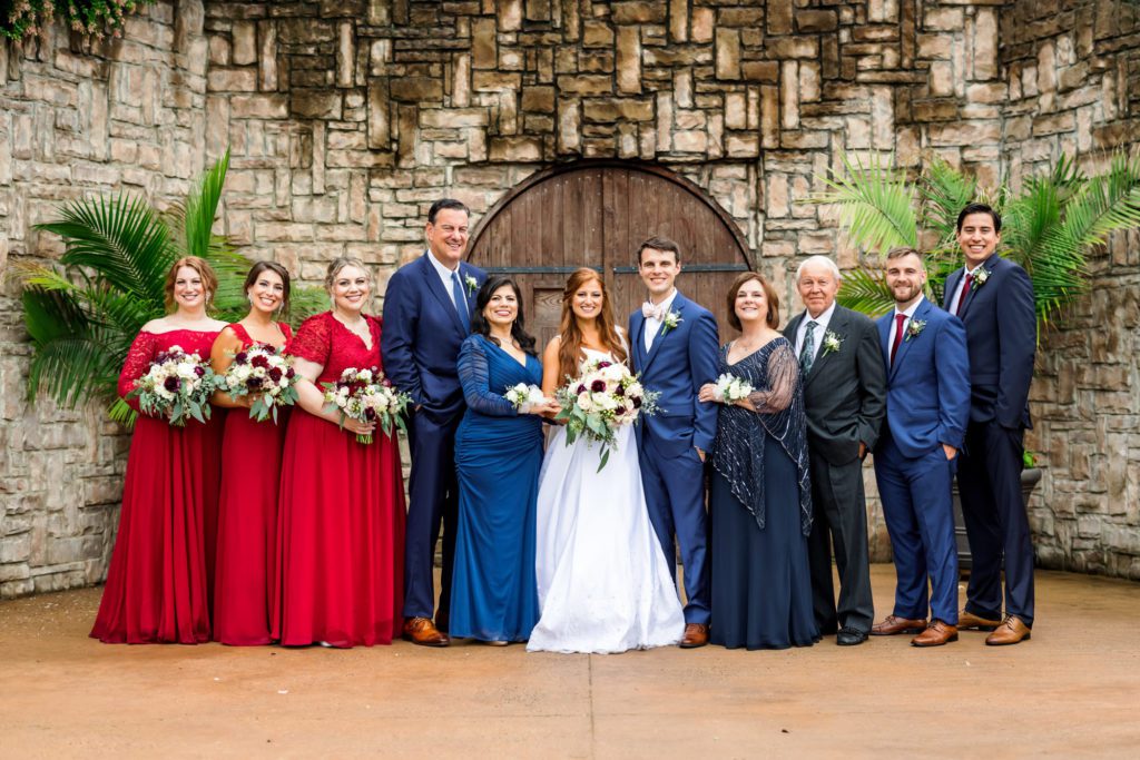 wedding party portraits with red bridesmaid dresses, and navy groomsmen suits