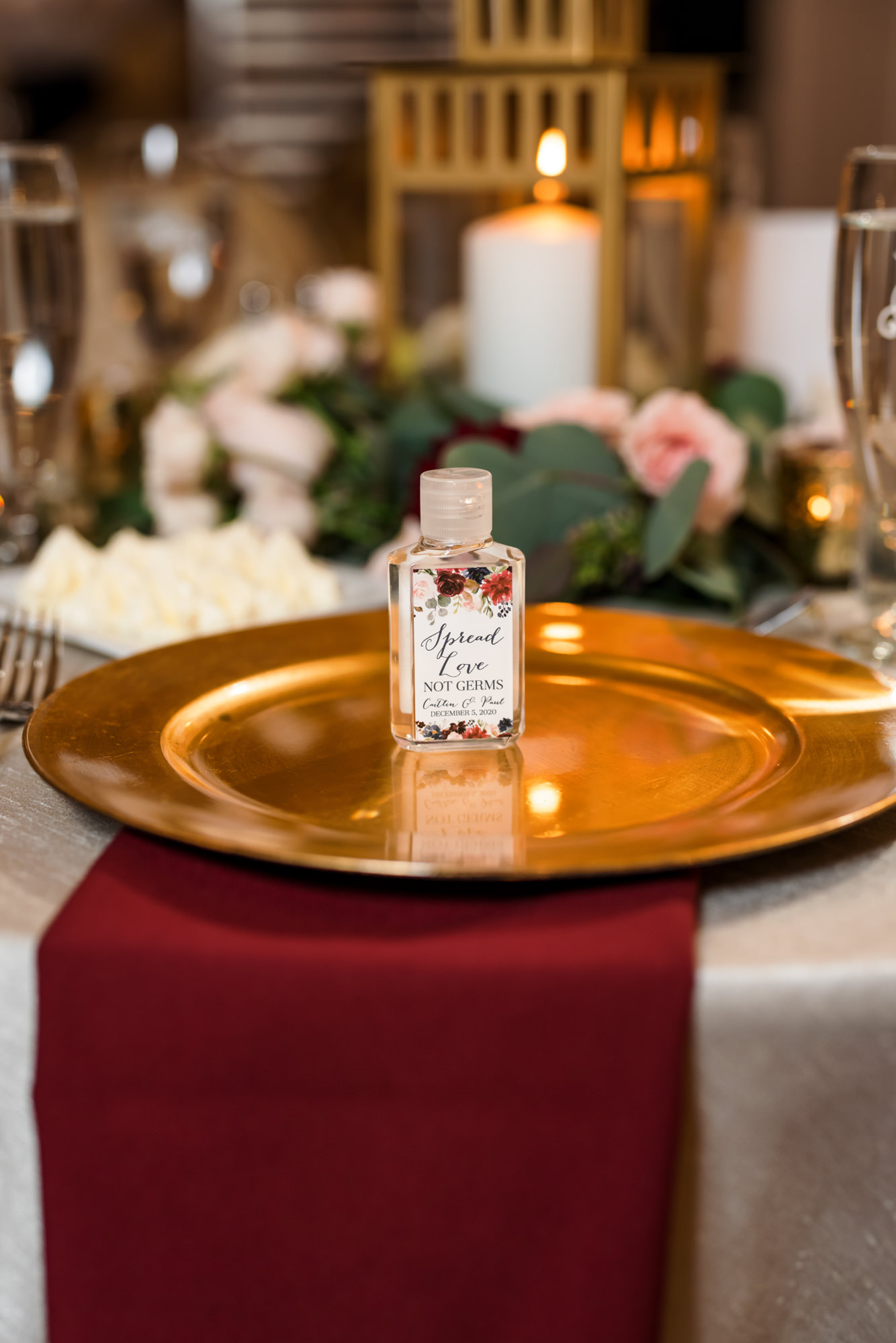 gold wedding plate with small bottle on wedding table