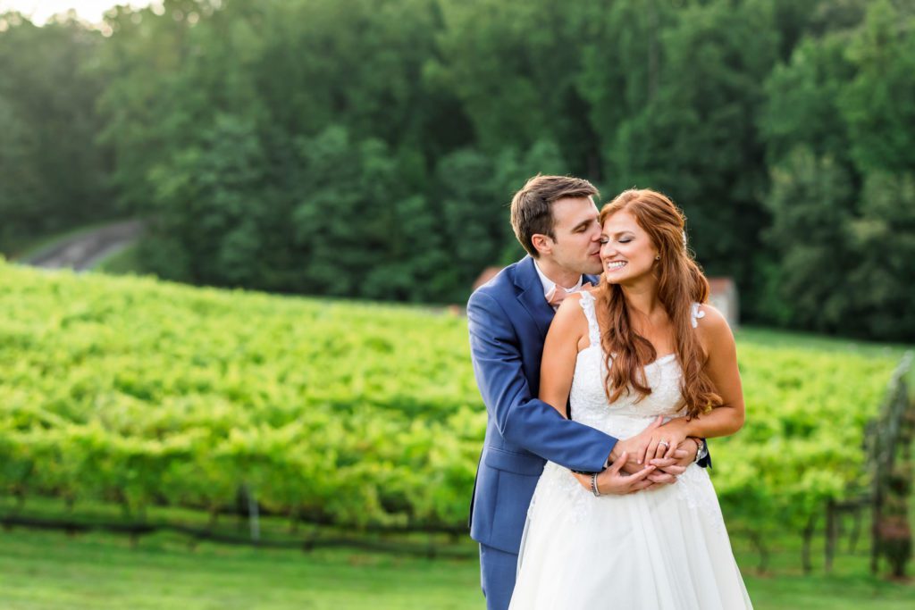 wedding couple embracing during outdoor bridals at potomac point winery