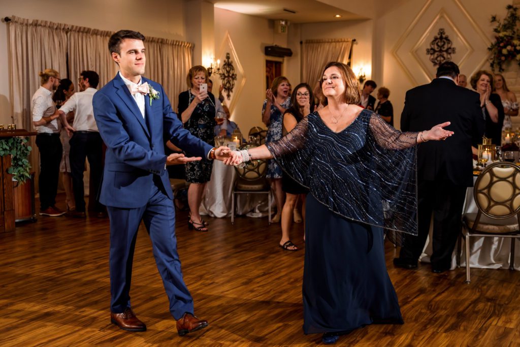 groom dancing with mother on wedding day