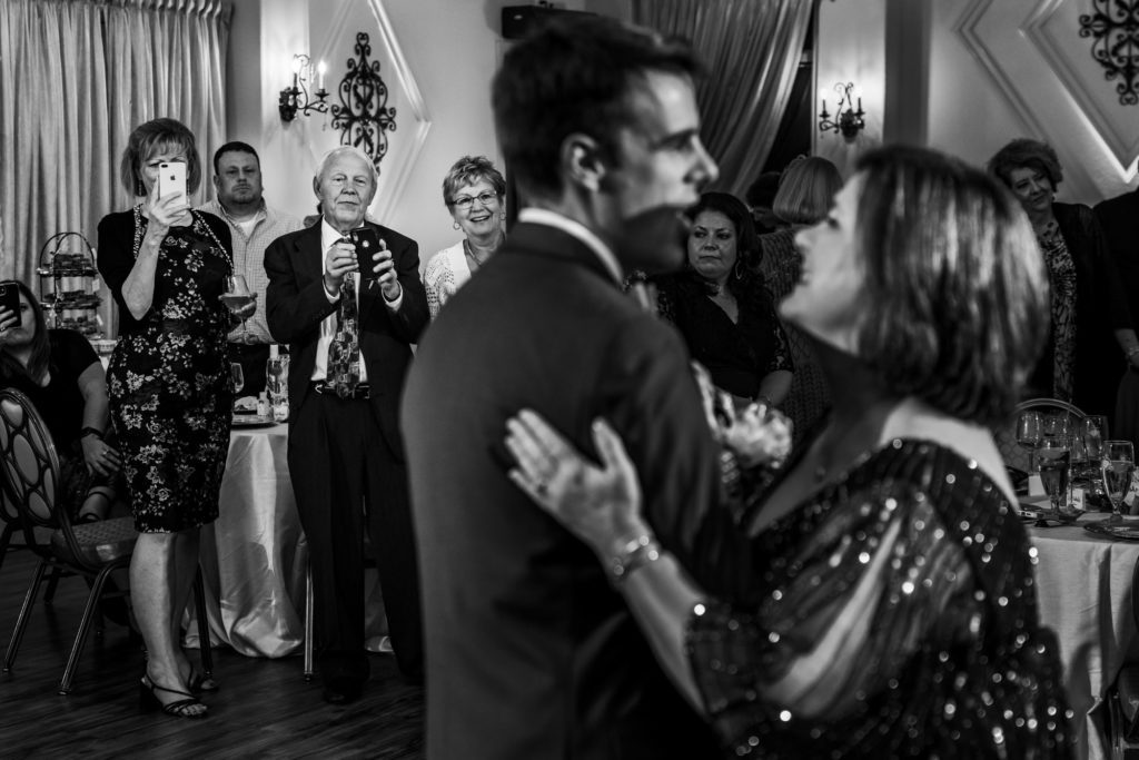 black and white portrait of groom dancing with mother at summer potomac point winery wedding
