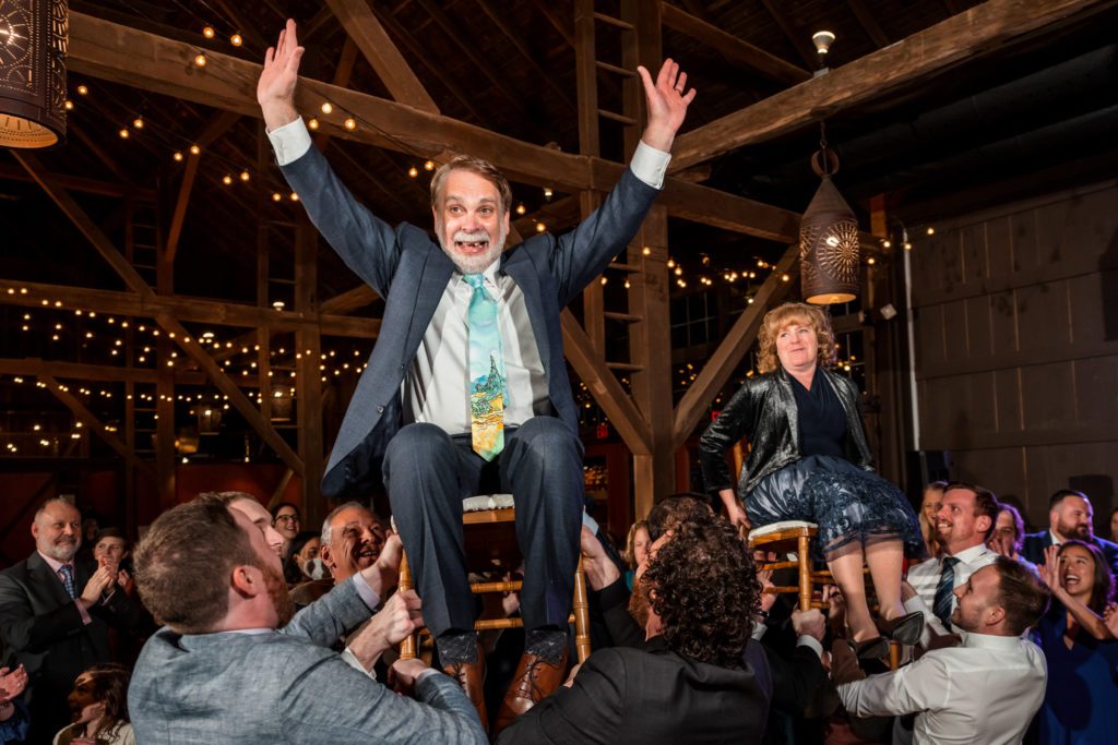 guests being lifted on chairs during jewish wedding reception