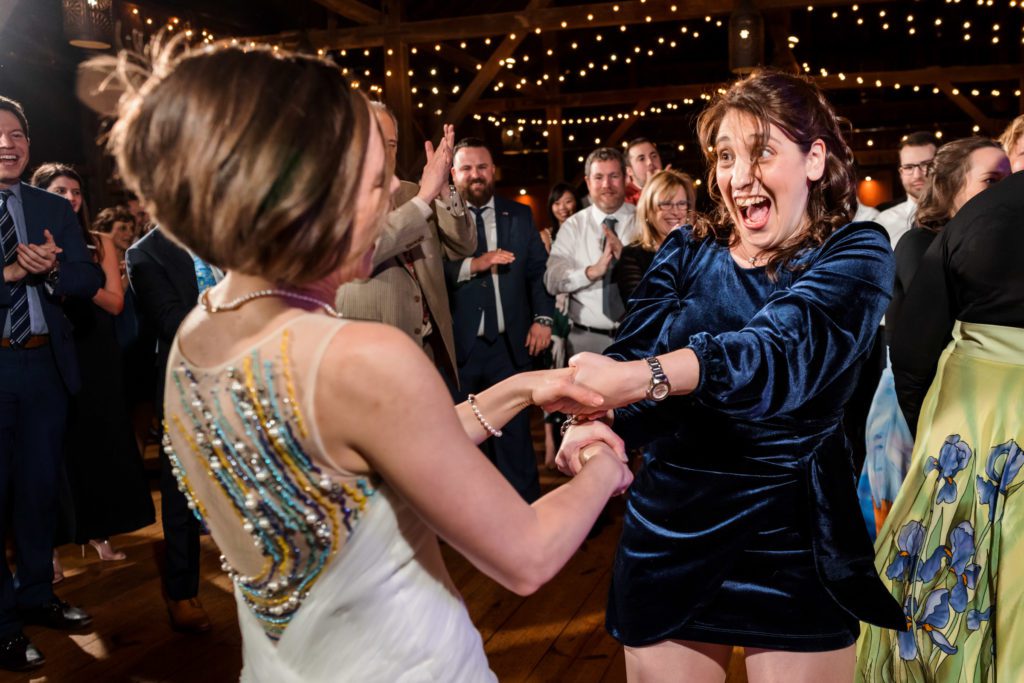 bride dancing with wedding guest on dance floor 
