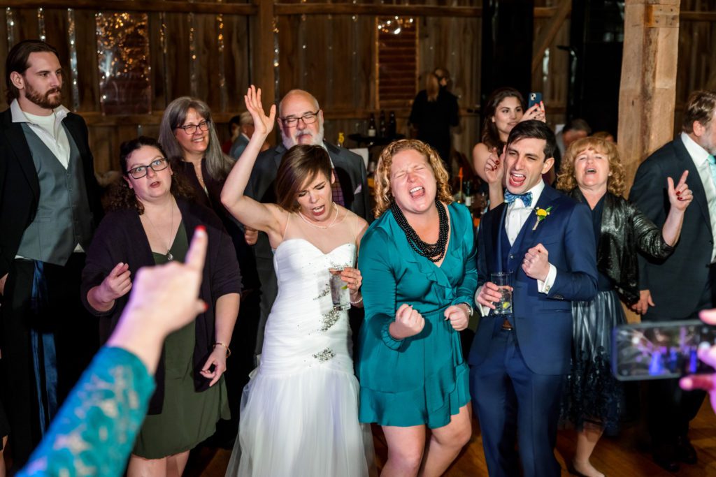 bride and groom celebrating with family and friends at jewish wedding reception