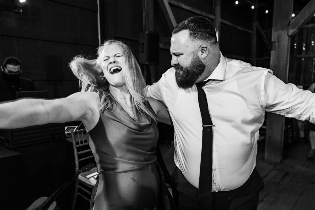 black and white portrait of wedding guests dancing