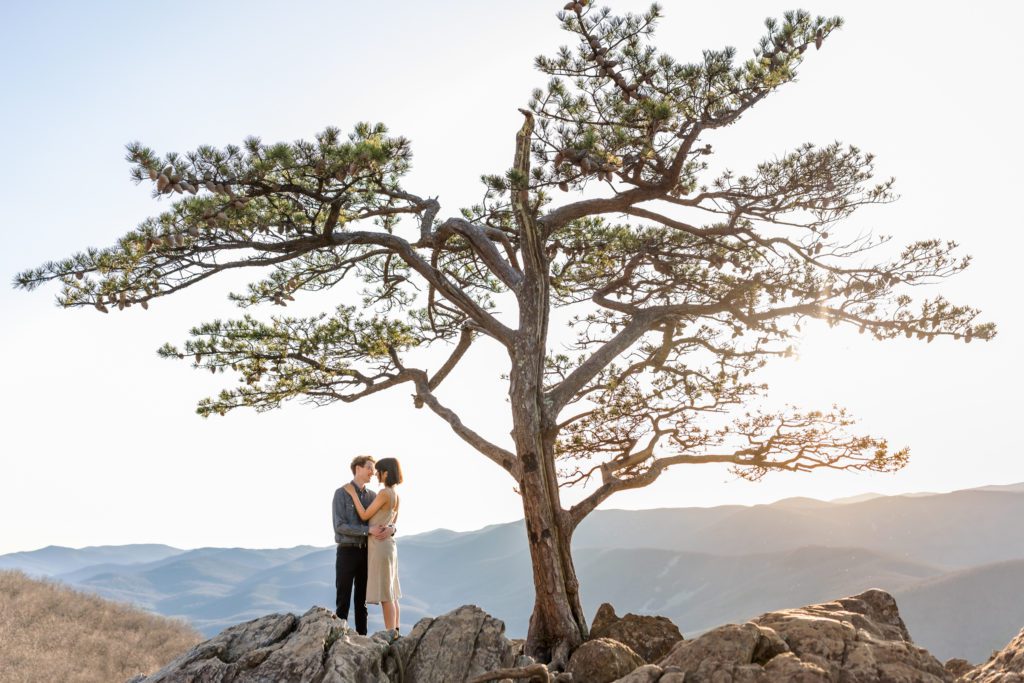 couple kissing at top of ravens roost during outdoor engagement session