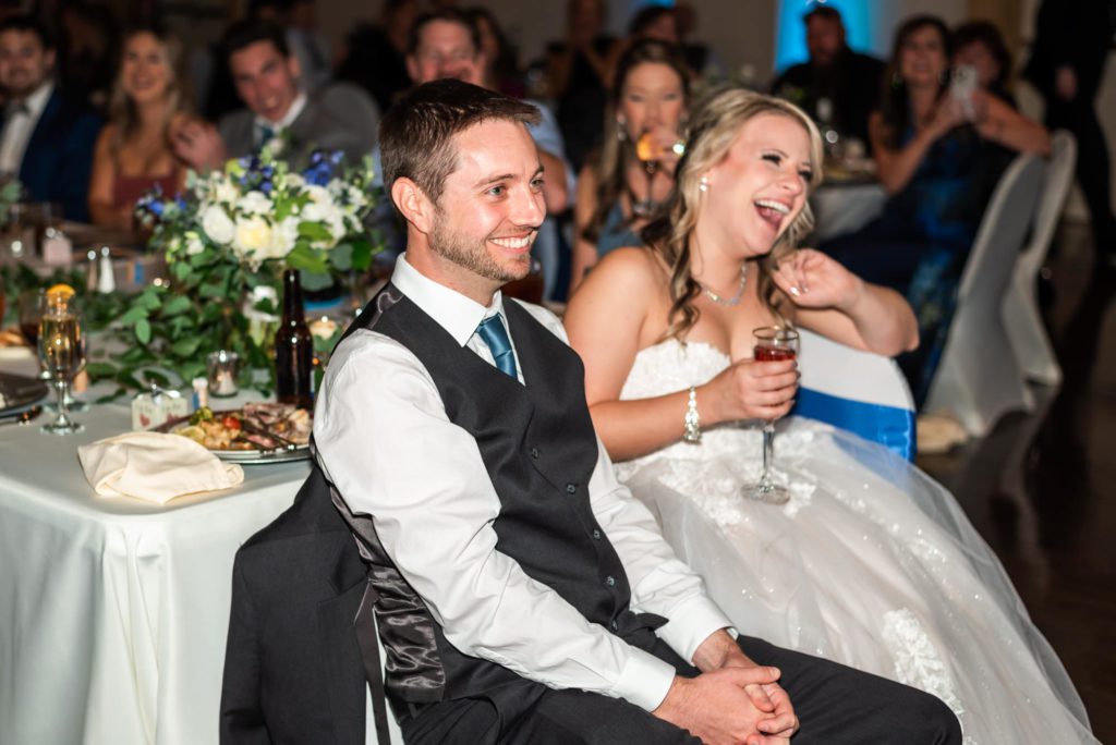 bride and groom laughing during toasts and speeches
